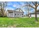 Backyard features mature trees and a patio area at 8240 Shelbyville Rd, Indianapolis, IN 46259