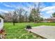 Spacious backyard featuring a concrete patio, fire pit, and ample green space at 8240 Shelbyville Rd, Indianapolis, IN 46259