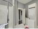 Bathroom featuring a stand-up shower, tiled floor, and washer/dryer at 8240 Shelbyville Rd, Indianapolis, IN 46259