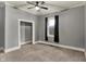 This bedroom has gray walls, ceiling fan and plush carpeting at 8240 Shelbyville Rd, Indianapolis, IN 46259