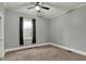 Cozy bedroom featuring neutral carpet, paint and a window with natural light at 8240 Shelbyville Rd, Indianapolis, IN 46259