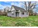 Charming exterior view of a gray home with a well-maintained lawn and mature trees at 8240 Shelbyville Rd, Indianapolis, IN 46259