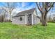 Charming home featuring gray siding, a well-maintained lawn, and mature trees at 8240 Shelbyville Rd, Indianapolis, IN 46259