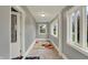 Light-filled hallway showcasing a decorative rug and large windows at 8240 Shelbyville Rd, Indianapolis, IN 46259