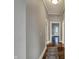 Hallway with hardwood floors, neutral walls, and doorways leading to other rooms at 8240 Shelbyville Rd, Indianapolis, IN 46259