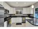Bright kitchen featuring granite countertops, stainless appliances, and custom white cabinets at 8240 Shelbyville Rd, Indianapolis, IN 46259