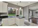 Bright kitchen showcasing white cabinets, dark countertops, and a view of the backyard at 8240 Shelbyville Rd, Indianapolis, IN 46259