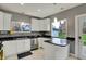 Well-lit kitchen with white cabinets, granite countertops, and stainless steel appliances at 8240 Shelbyville Rd, Indianapolis, IN 46259