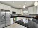 Modern kitchen with stainless steel appliances, granite countertops, and white cabinetry at 8240 Shelbyville Rd, Indianapolis, IN 46259