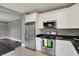 Kitchen view featuring stainless appliances and white cabinetry and view into dining room at 8240 Shelbyville Rd, Indianapolis, IN 46259
