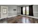 Bright living room featuring wood floors, neutral walls, and a decorative glass door at 8240 Shelbyville Rd, Indianapolis, IN 46259