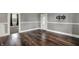 Spacious living room with hardwood floors, neutral paint, and an inviting entryway at 8240 Shelbyville Rd, Indianapolis, IN 46259
