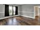 Inviting living room with hardwood floors, neutral walls, and large windows at 8240 Shelbyville Rd, Indianapolis, IN 46259