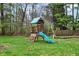 Backyard wooden playset featuring a slide, climbing wall, and swings at 8240 Shelbyville Rd, Indianapolis, IN 46259