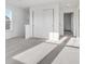 Bright bedroom with a window, light grey carpet, closet, and ensuite bathroom at 908 Stonehaven Dr, Indianapolis, IN 46239