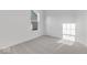 Bright, carpeted bedroom features neutral colors, window, and white door at 908 Stonehaven Dr, Indianapolis, IN 46239