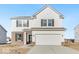 Two story home featuring a front-facing two car garage, partial brick facade, and a symmetrical facade at 908 Stonehaven Dr, Indianapolis, IN 46239