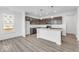 Kitchen featuring hardwood floors, an island, modern appliances, and lots of natural light at 908 Stonehaven Dr, Indianapolis, IN 46239