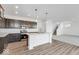 Open concept kitchen with an island, modern appliances, and hardwood floors at 908 Stonehaven Dr, Indianapolis, IN 46239