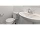 Clean, minimalist powder room with toilet and pedestal sink at 908 Stonehaven Dr, Indianapolis, IN 46239