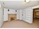 A view of the basement, featuring a brick fireplace and built in shelves at 7912 E St Joseph St, Indianapolis, IN 46219