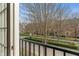 Balcony view showcasing a well-maintained neighborhood with mature trees and manicured landscaping at 12820 University Cres # 2D, Carmel, IN 46032