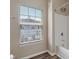 Bathroom with modern fixtures, white tile shower, and a window with natural light at 12820 University Cres # 2D, Carmel, IN 46032