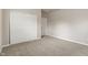 Cozy bedroom with plush carpeting, white sliding door closet, and natural light at 12820 University Cres # 2D, Carmel, IN 46032