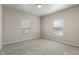 Bright bedroom featuring neutral walls, plush carpeting, and natural light through large windows at 12820 University Cres # 2D, Carmel, IN 46032