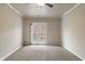 Empty bedroom with neutral carpet, bright lighting and balcony at 12820 University Cres # 2D, Carmel, IN 46032