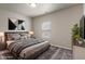 Bedroom features a large bed, neutral walls, carpet and a window with lots of light at 12820 University Cres # 2D, Carmel, IN 46032
