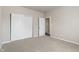Bedroom featuring neutral walls, carpet, closet and a door at 12820 University Cres # 2D, Carmel, IN 46032