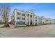 Attractive exterior with classical columns, symmetrical design, black shutters, and well-maintained landscaping at 12820 University Cres # 2D, Carmel, IN 46032