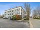 Apartment building with parking spaces, landscaping, and sidewalks at 12820 University Cres # 2D, Carmel, IN 46032