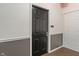 Hallway featuring a dark entry door labeled '2D', and neutral wall tones with a decorative trim at 12820 University Cres # 2D, Carmel, IN 46032