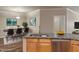 Open concept kitchen features stainless steel appliances, wood cabinets, and laminate countertops at 12820 University Cres # 2D, Carmel, IN 46032