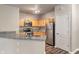Open concept kitchen features stainless steel appliances, wood cabinets, and laminate countertops at 12820 University Cres # 2D, Carmel, IN 46032