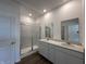 Modern bathroom with double vanity, granite countertops, and a glass-enclosed shower, offering a spa-like retreat at 273 Lar Lan Dr, Danville, IN 46122