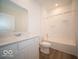Clean and modern bathroom features white cabinets, a quartz countertop, and a shower-tub combo at 273 Lar Lan Dr, Danville, IN 46122