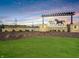 Stone entrance sign for Miles Farm community displaying horse logo set against a colorful sky at 273 Lar Lan Dr, Danville, IN 46122