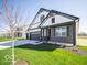 Inviting curb appeal with a three-car garage, manicured lawn, and modern design elements at 273 Lar Lan Dr, Danville, IN 46122