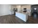 Bright kitchen with white cabinetry, stainless steel appliances, granite countertops, and a large center island at 273 Lar Lan Dr, Danville, IN 46122