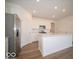 Kitchen features white cabinets, stainless appliances, and island with counter seating at 273 Lar Lan Dr, Danville, IN 46122