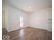 Open concept living room with wood floors and a door leading to the backyard at 273 Lar Lan Dr, Danville, IN 46122