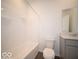 Clean bathroom with a tub shower, white tile surround, and a gray vanity, creating a functional space at 287 Lar Lan Dr, Danville, IN 46122