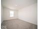 Bedroom featuring neutral carpet, a window, and light walls at 287 Lar Lan Dr, Danville, IN 46122
