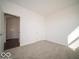 Inviting bedroom with plush carpet, a view to the outside, and a connected doorway to a hall for convenience at 287 Lar Lan Dr, Danville, IN 46122