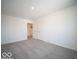 Bedroom featuring neutral carpet, light walls, and double doors at 287 Lar Lan Dr, Danville, IN 46122