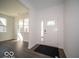 Bright entryway with hardwood floors, a white front door with a glass window, and a view into the living area at 287 Lar Lan Dr, Danville, IN 46122