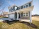 Front and side view of a two-story home with a covered porch and three-car garage at 287 Lar Lan Dr, Danville, IN 46122